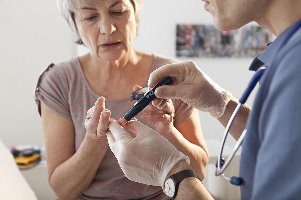 Nurse Measuring Blood Glucose Level diabetes management fairview rehab foresthills queens nyc