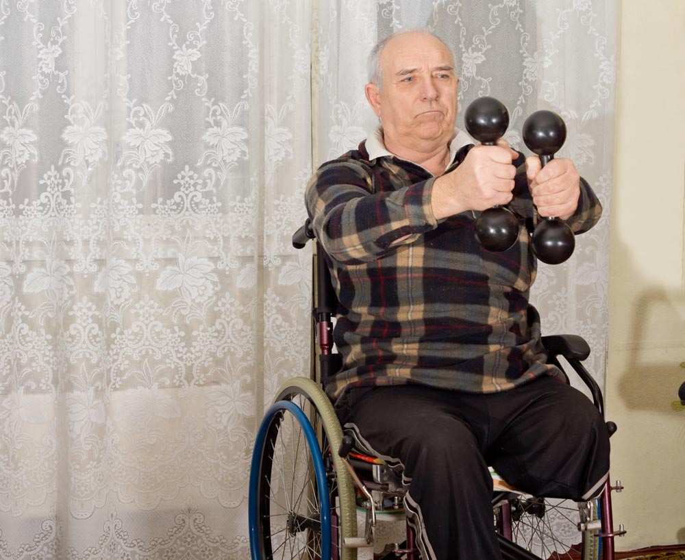 Senior handicapped man exercising to build muscle mass