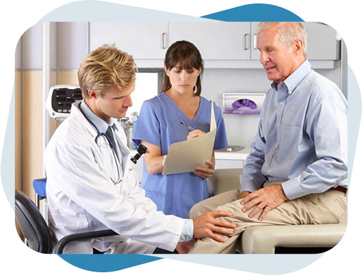 Doctor checking knee joint of a senior man who had joint replacement surgery while nurse is taking notes.