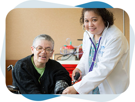 Nurse checking blood pressure of a senior woman.