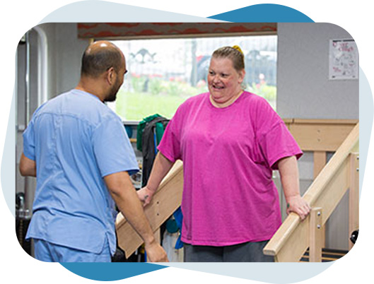 Fairview Rehab therapist helping a women with occupational therapy