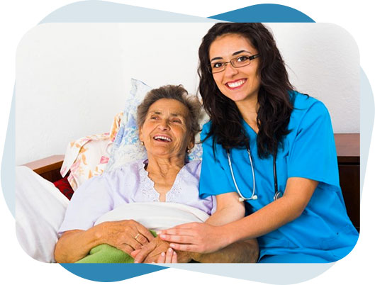 Nurse holding hands of a senior woman suffering from Parkinson disease lying on the bed.