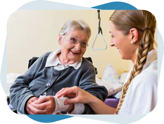 Nurse checking bandage on a senior woman's' hand to provide wound care.