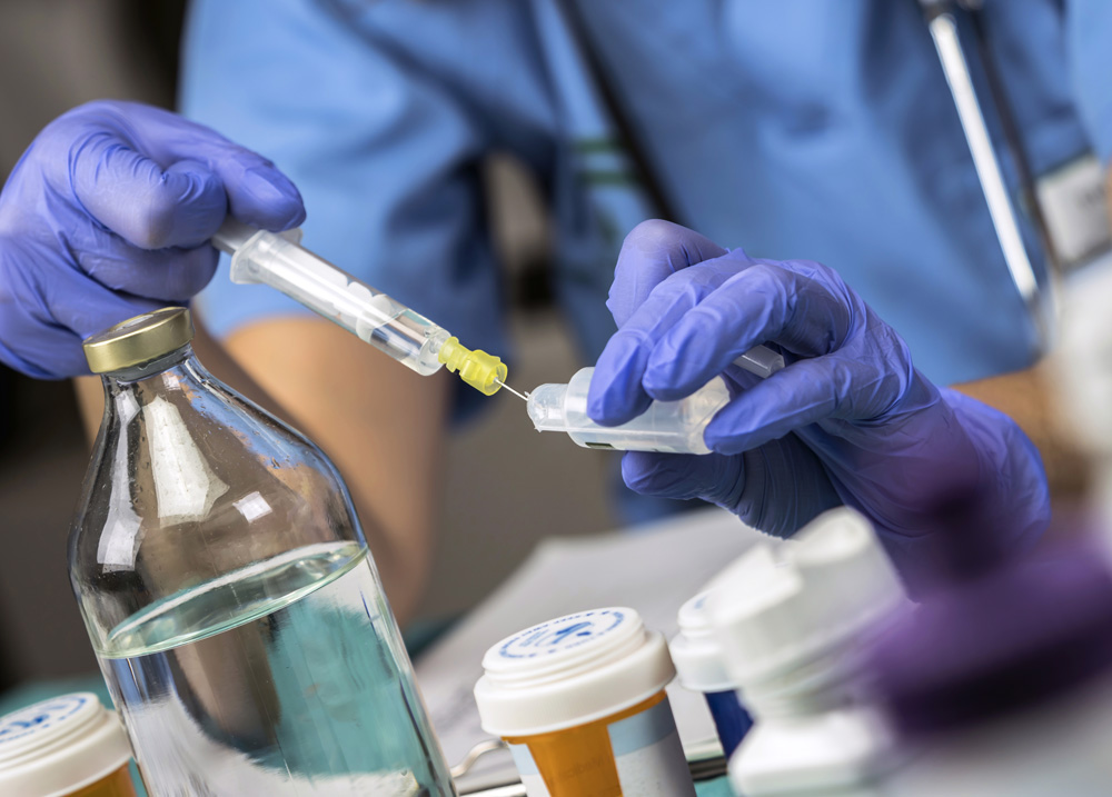 Nurse preparing medication for parenteral nutrition in a hospital, conceptual image