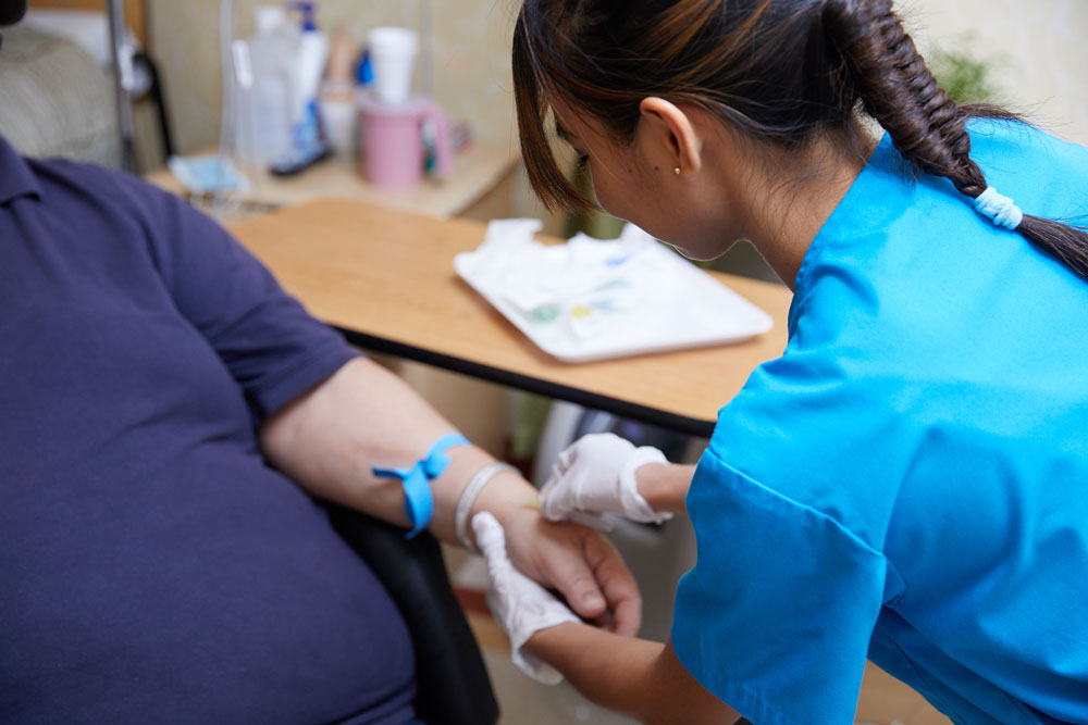 IV Therapy Nurse giving injection to a patient at Fairview Rehab & Nursing Home