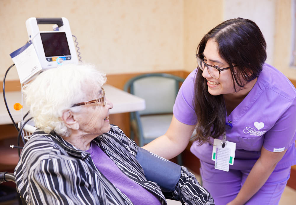 Nurse helping senior patient to recover from a heart attack