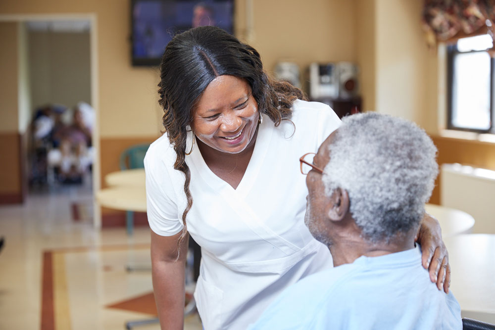 Fairview Rehab staff providing speech therapy for adults to a senior man