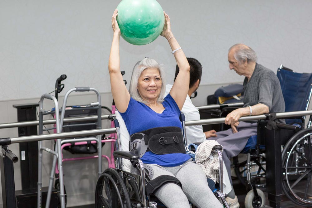 Elderly women doing exercise for cardiac rehab after bypass surgery