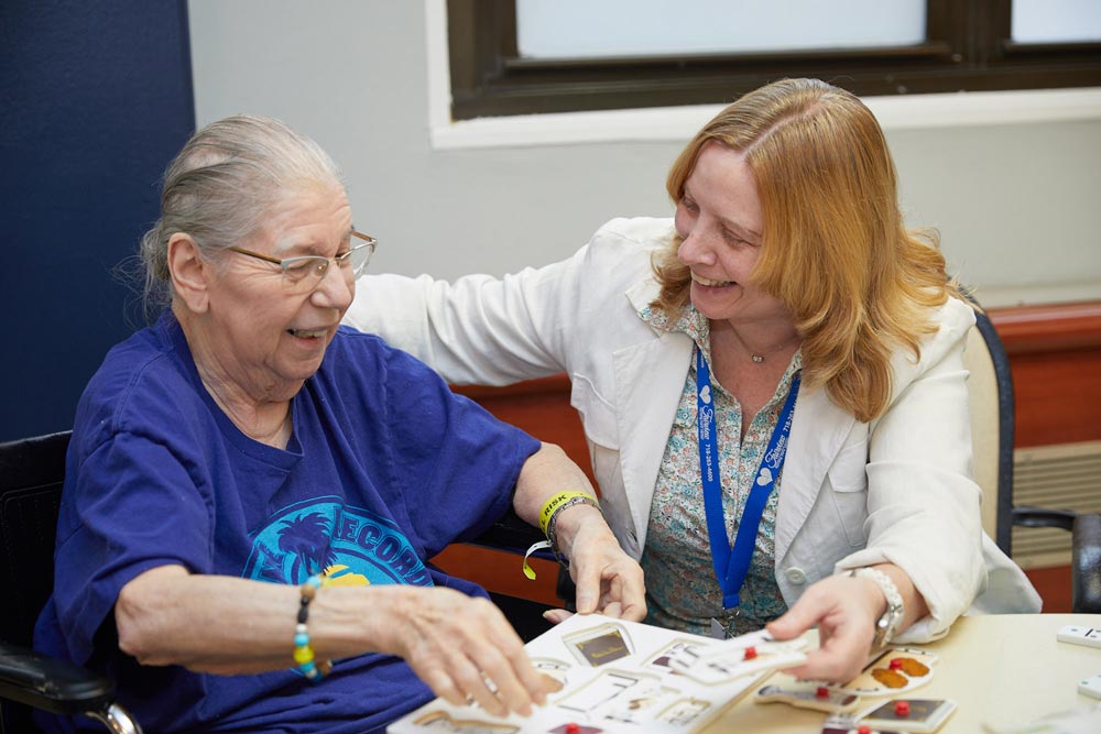 Nursing staff providing nursing care to elderly women