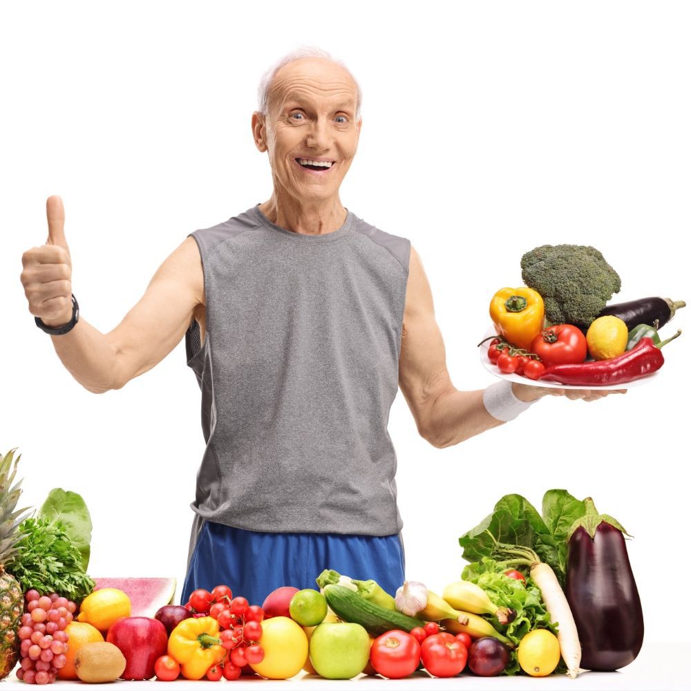 Happy and healthy elderly man promoting to eat vegetables to avoid viruses