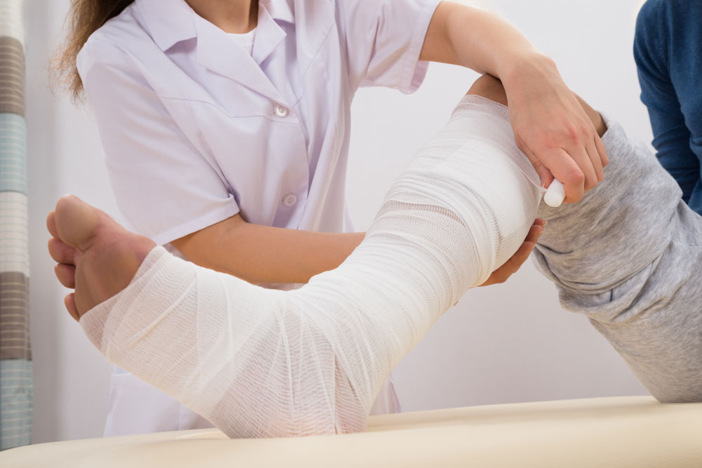 Doctor bandaging patient's leg that have diabetic wounds