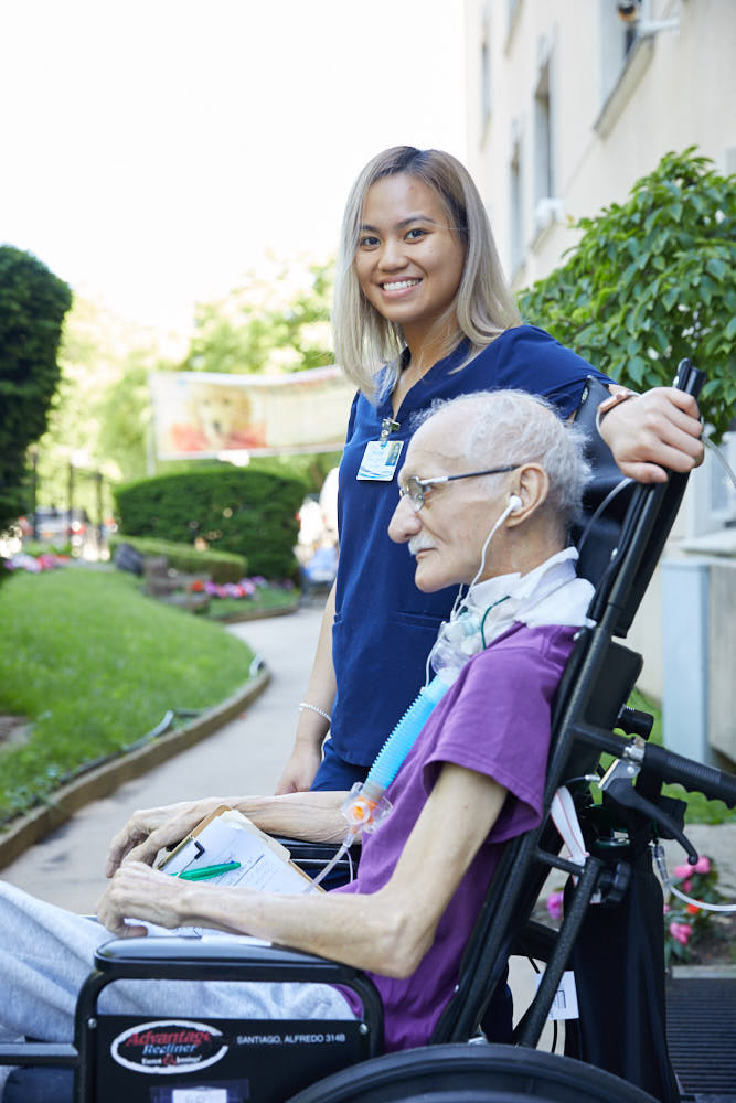 Nurse taking care of an elderly man suffering from wheezing