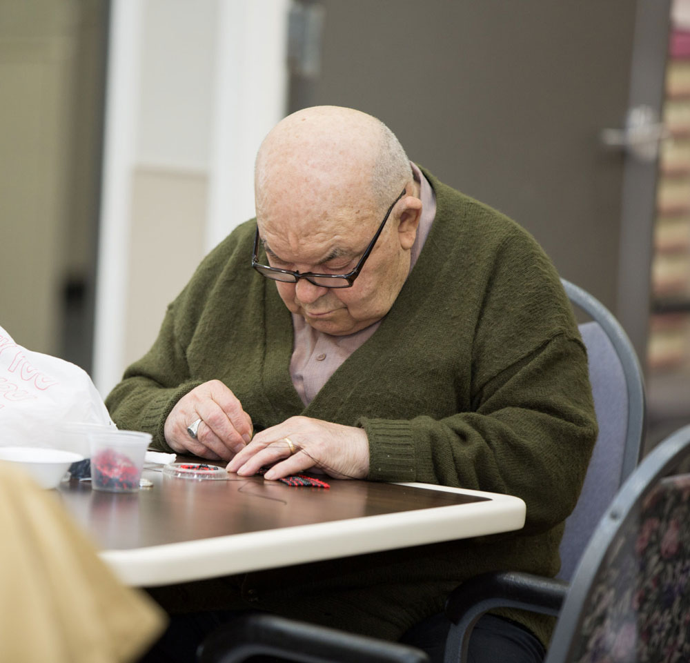 Elderly man getting occupational therapy for multiple sclerosis