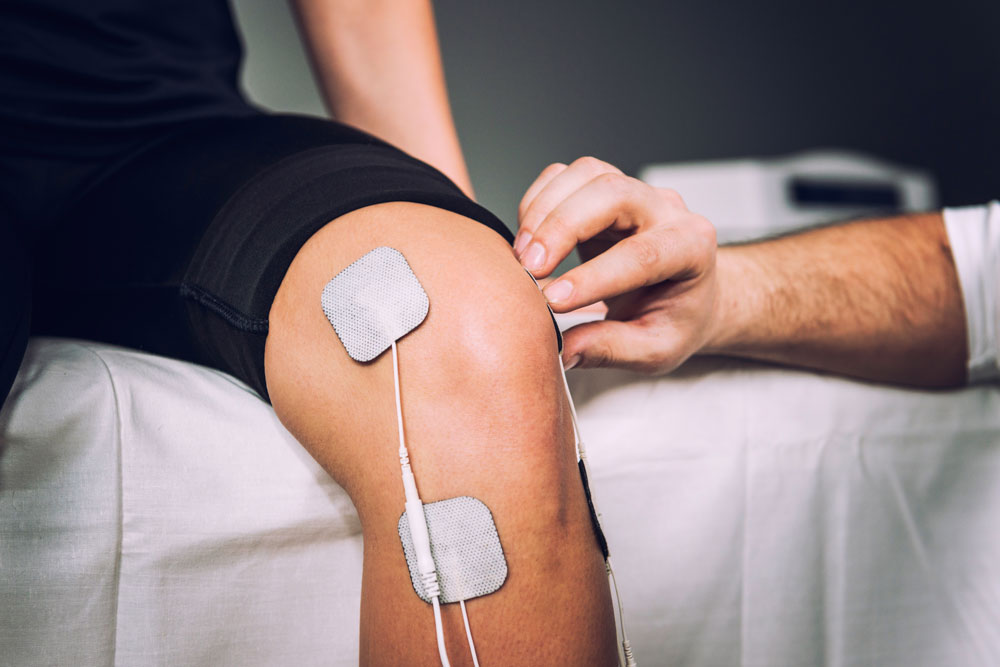 Electro stimulation as a part of physical therapy used to eliminate chronic knee pain