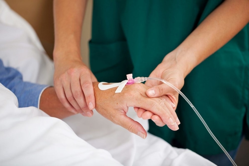 Nurse administering cannula of a patient as a part of IV treatment