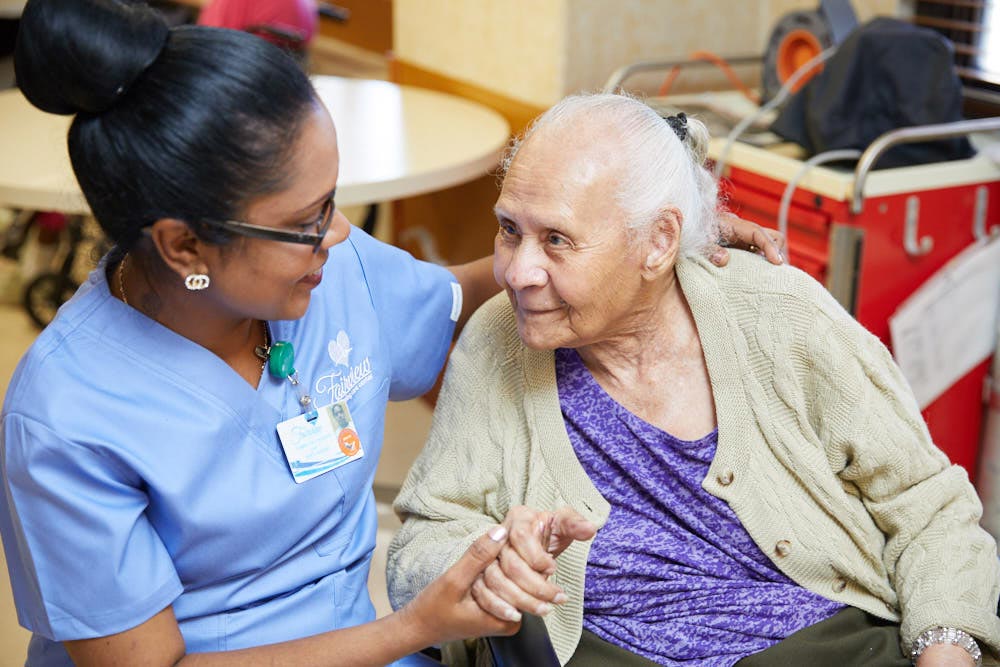 Neurological Rehabilitation Nurse providing Neurological Rehabilitation to an elderly woman