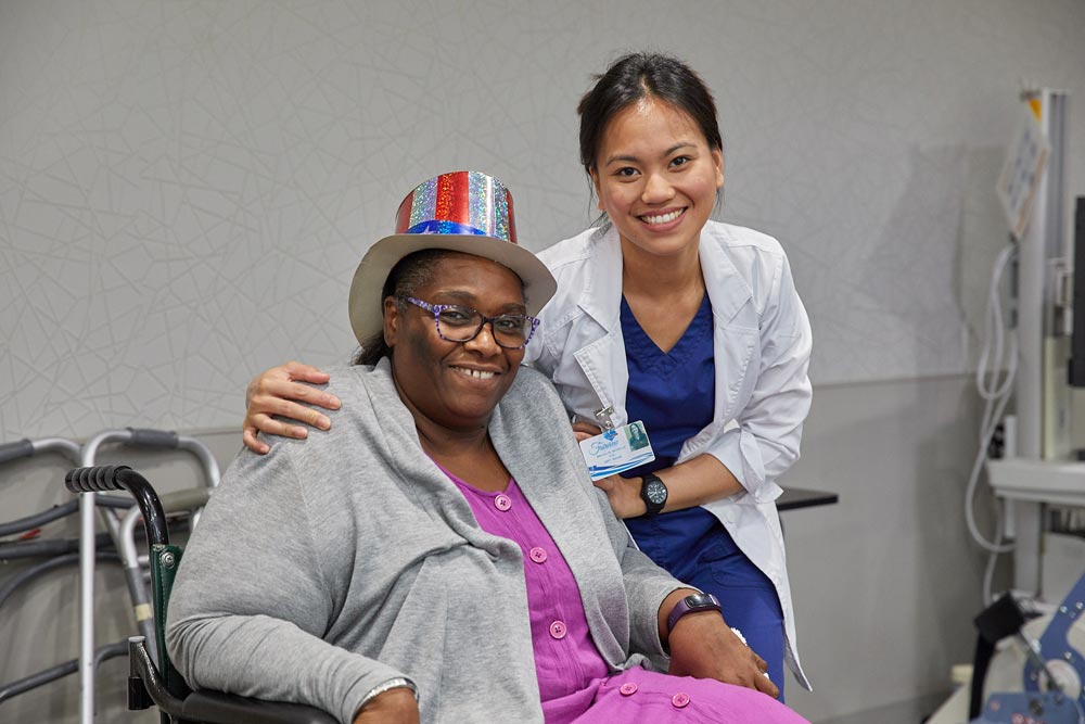 Multiple Sclerosis Rehab Elderly black woman smiling with rehab nurse after getting multiple sclerosis rehab