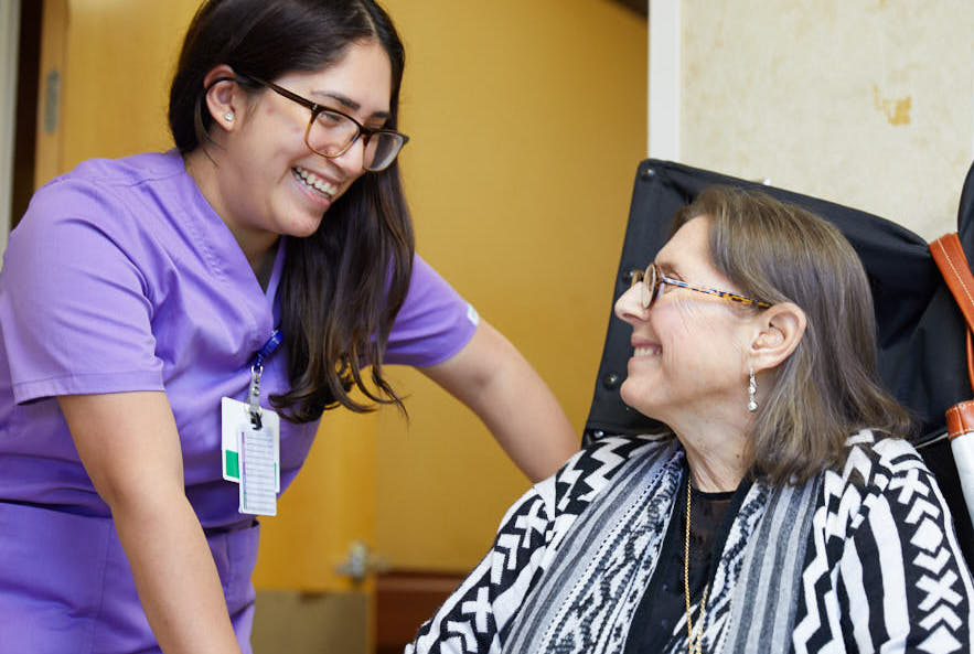 Nurse providing wound care to an elderly woman