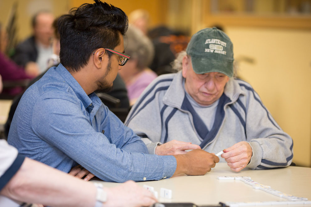 Elderly man living with a stroke and playing puzzle games as a part of stroke rehabilitation
