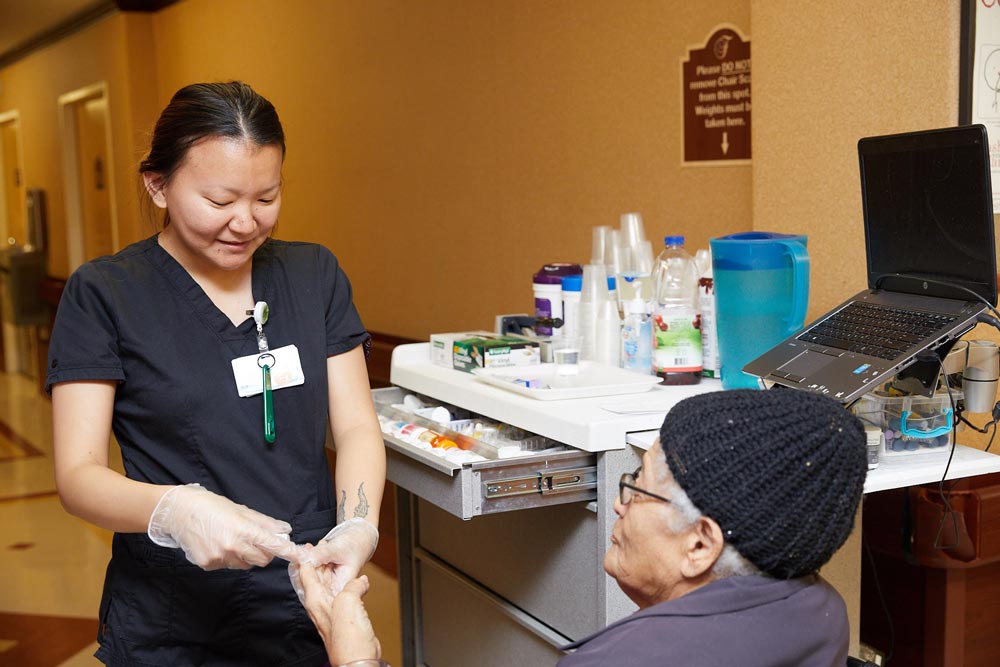 Nurse diagnosing elderly woman showing signs of infection