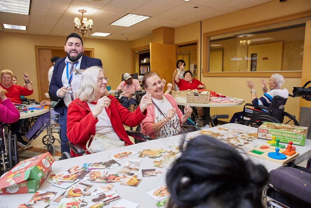 A group of senior people celebrating a holiday event as a part of inpatient rehab