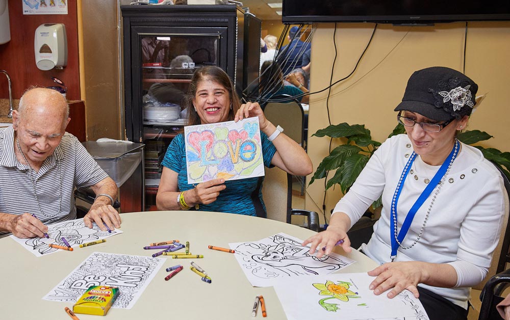 Senior patients with early signs of alzheimer's drawing sketches on papers to stop the condition from worsening.