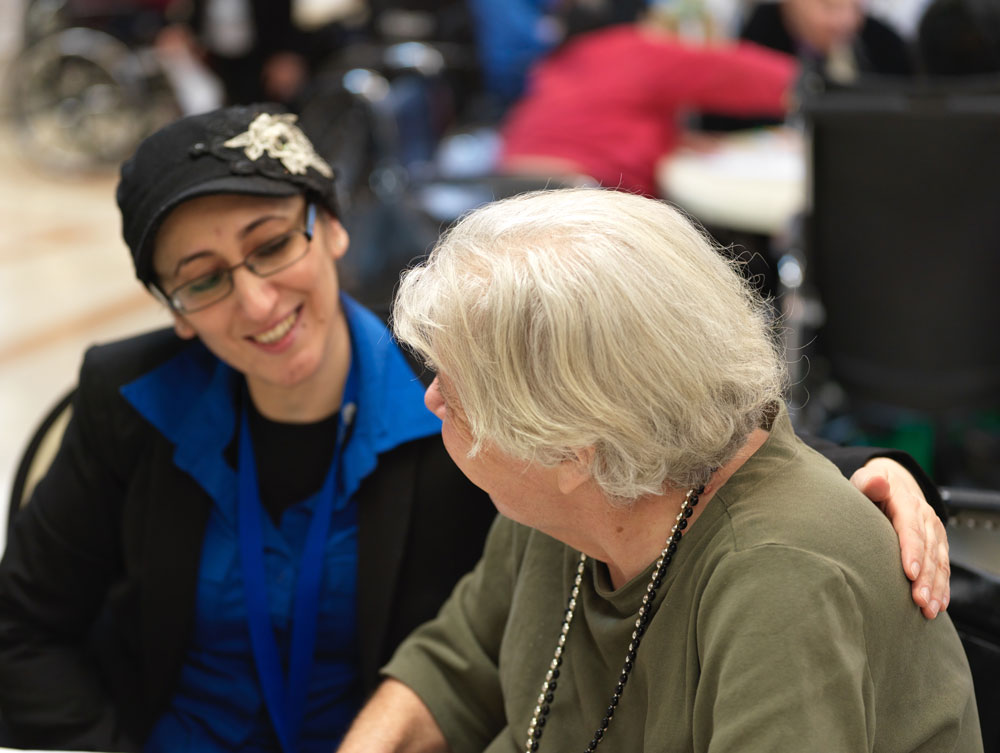 Nurse comforting an elderly woman suffering from Bone And Joint Infections