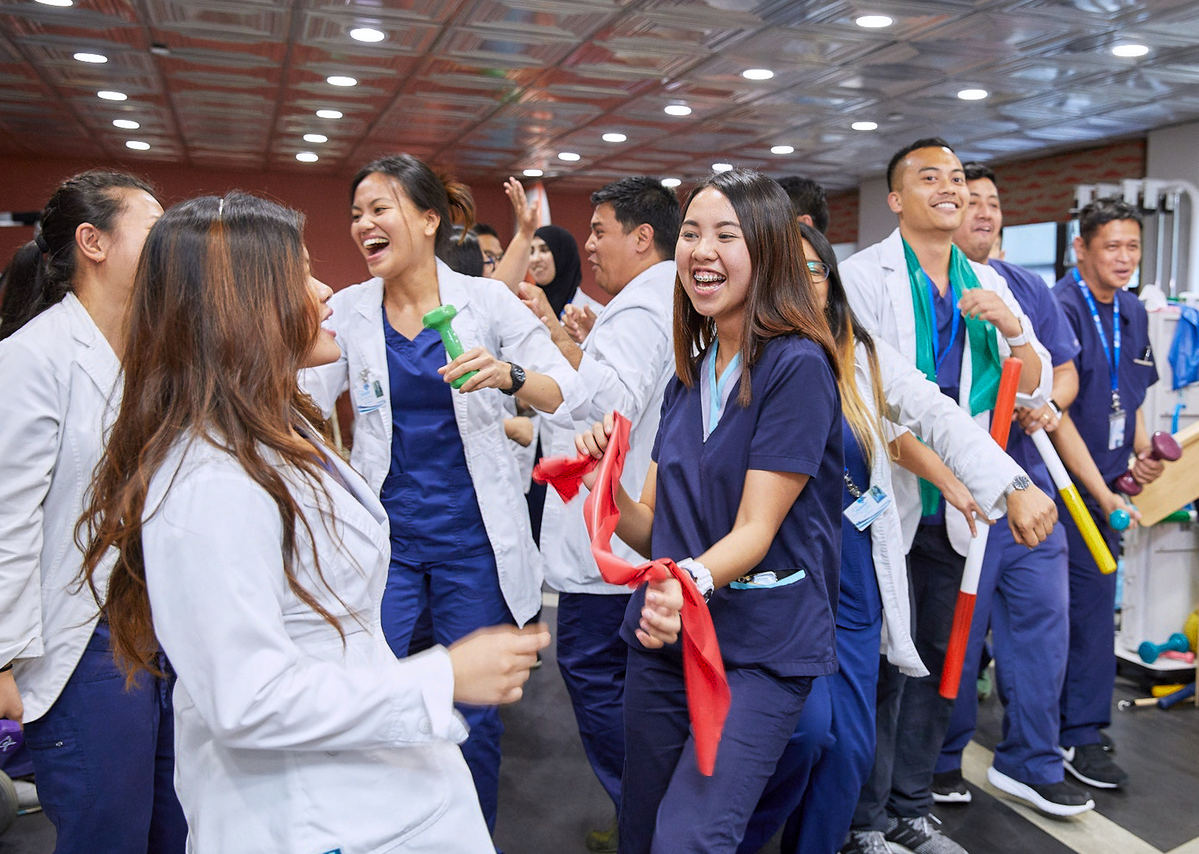 People in nursing homes dancing during fun activities event.