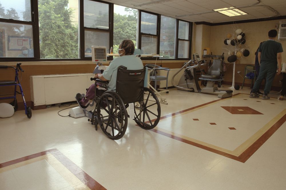 Elderly woman sitting on a wheelchair suffering from fluid in the lungs.