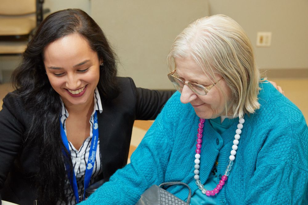 Nurse taking care of an elderly woman suffering from postherpetic neuralgia.