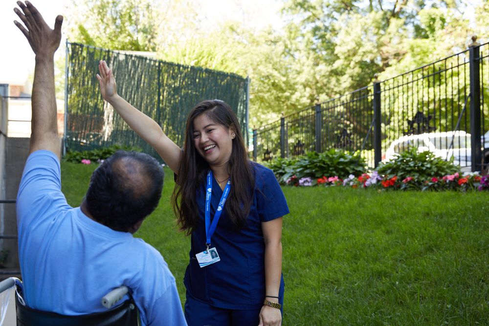 Therapist and patient doing physical therapy in the garden. Rehab after stent surgery.