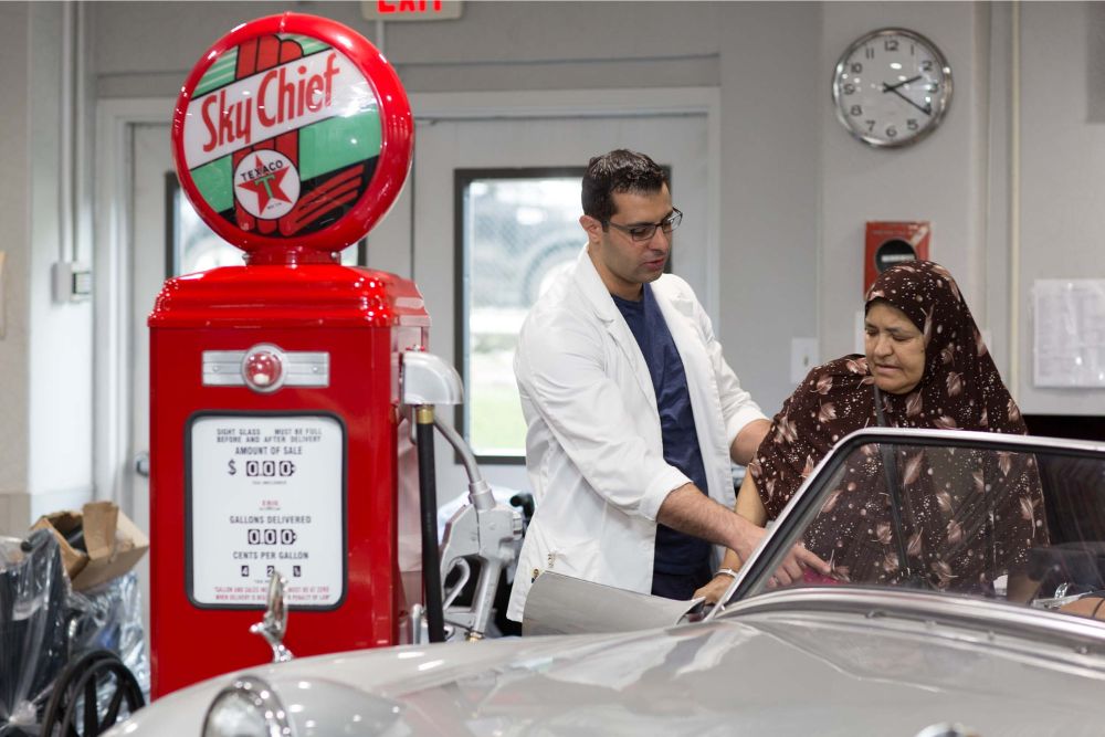 Physical therapist helping elderly woman with limited range of motion after knee replacement.